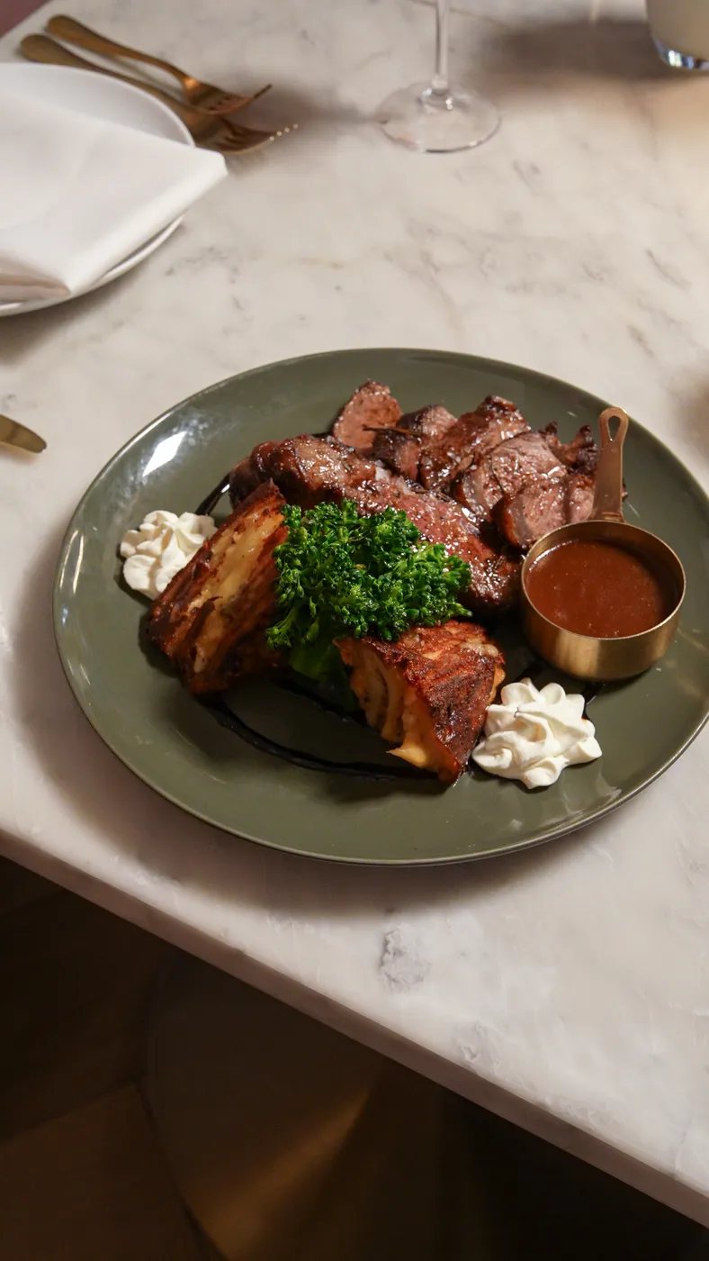 Sliced steak with sauce and whipped garnish